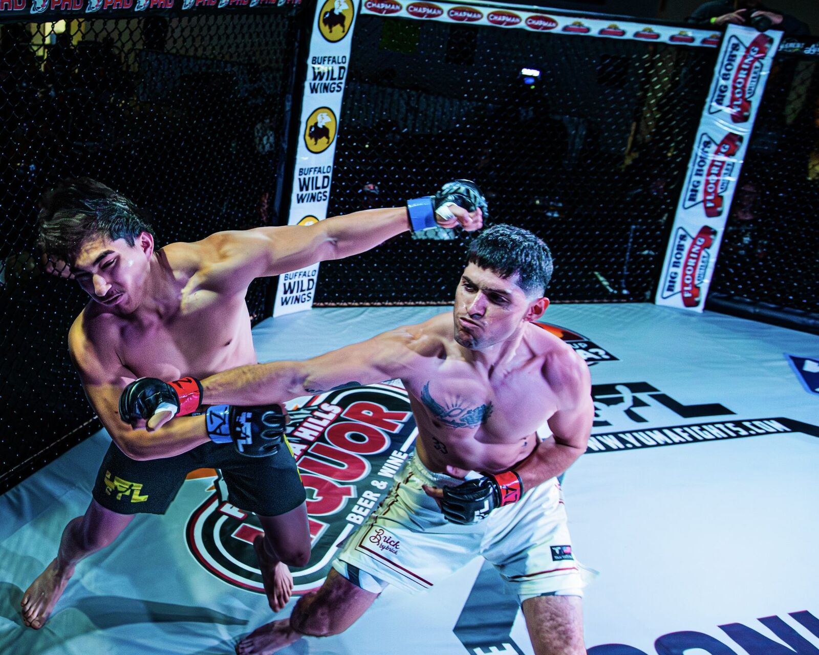 YFL fighters exchanging punches with Chapman and Buffalo Wild Wings sponsor banners visible