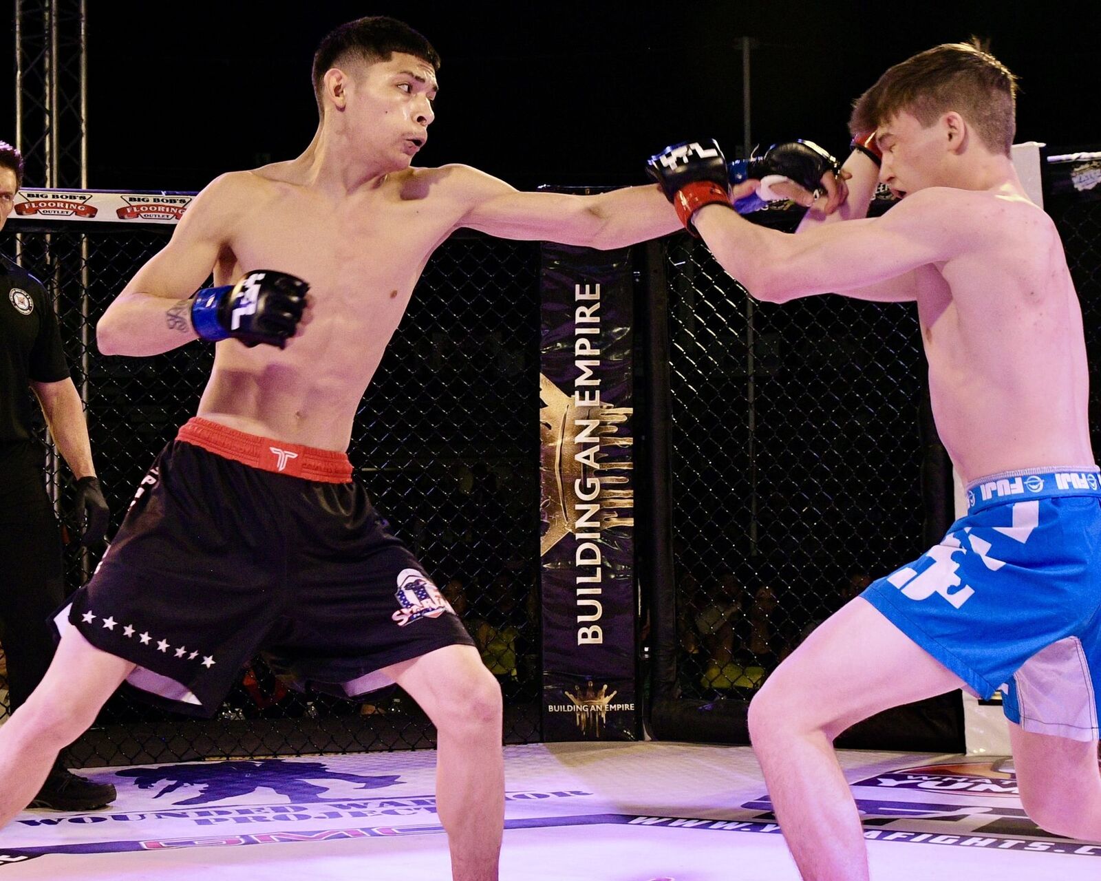 YFL fighters exchanging punches with Building an Empire banner visible